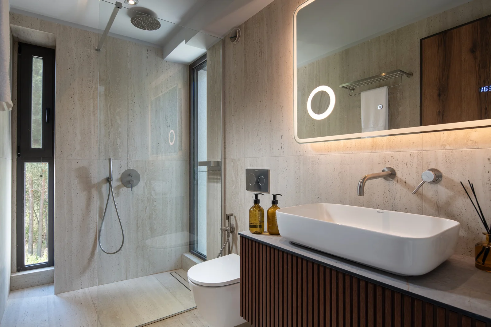 The stone-finished main bathroom