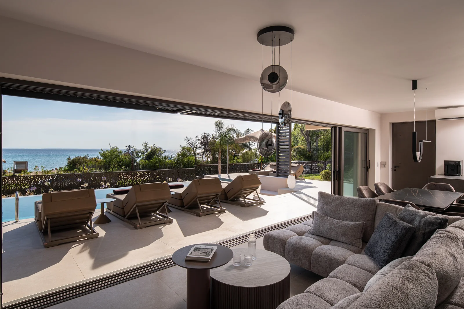 Sunlit terrace with arched stone openings overlooking the sea
